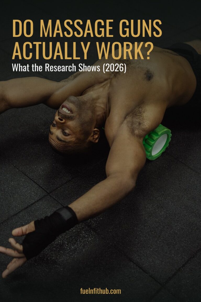 Athlete using a foam roller on the gym floor, a self-massage recovery method compared with massage gun recovery